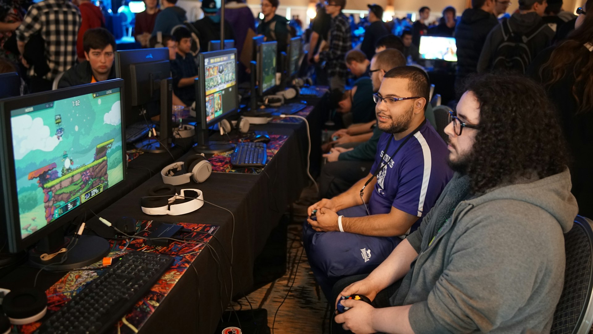 DragonHeroCitadel esports arena with players competing under stage lighting
